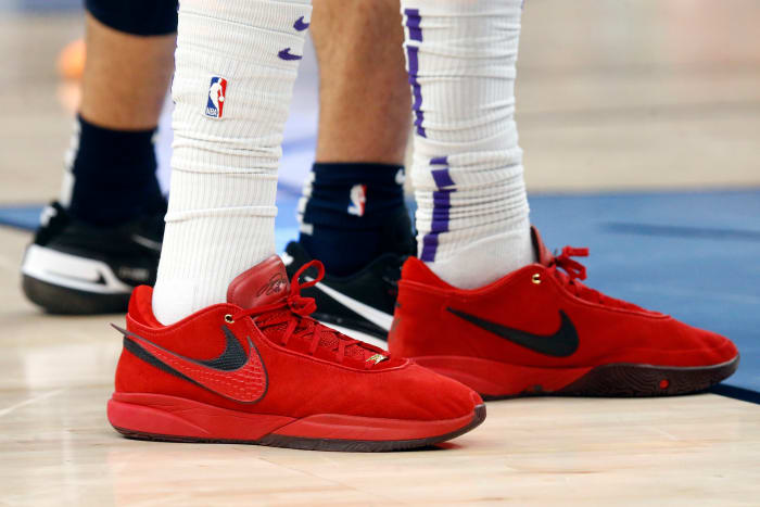 View of red and black Nike LeBron shoes.
